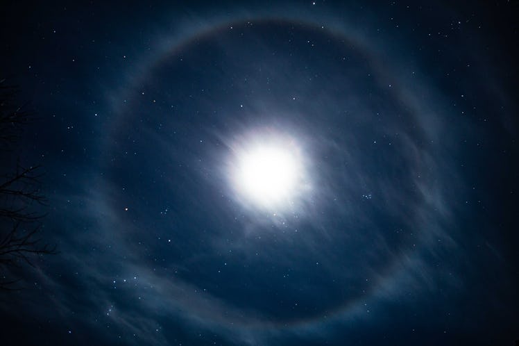 A lunar halo around the moon, showing multiple bands of color in its rainbow halo form, over East Ha...