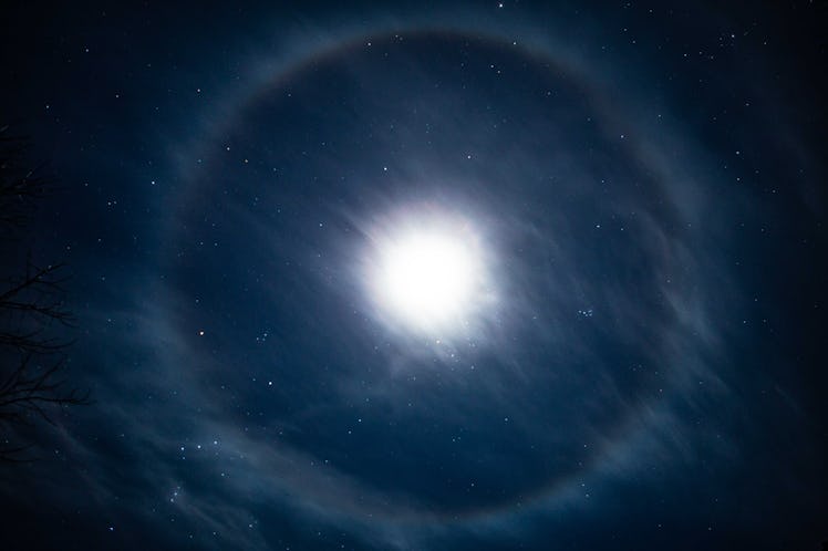 A lunar halo around the moon, showing multiple bands of color in its rainbow halo form, over East Ha...