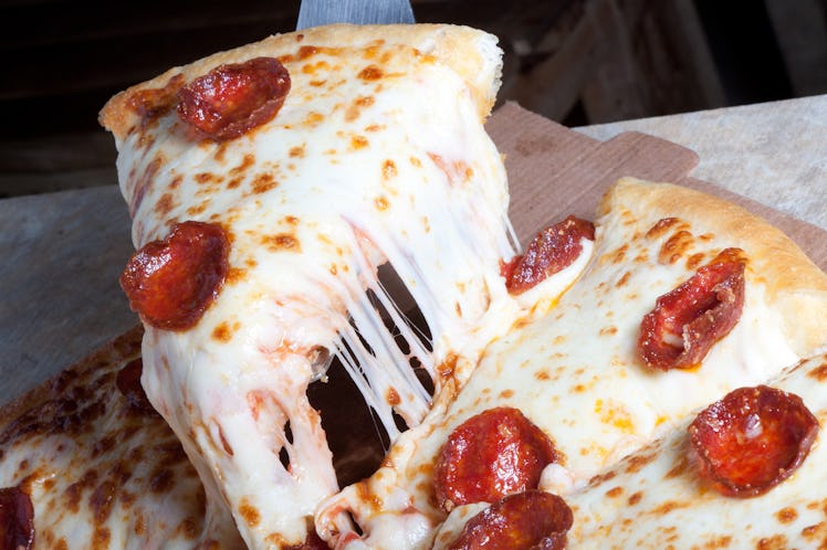 Pepperoni pizza slice  with  lots of cheese and pepperoni