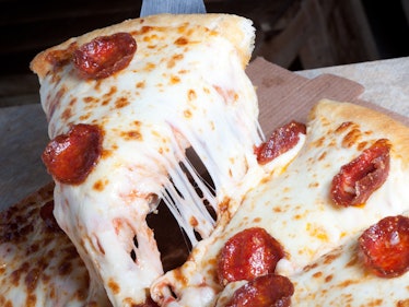Pepperoni pizza slice  with  lots of cheese and pepperoni