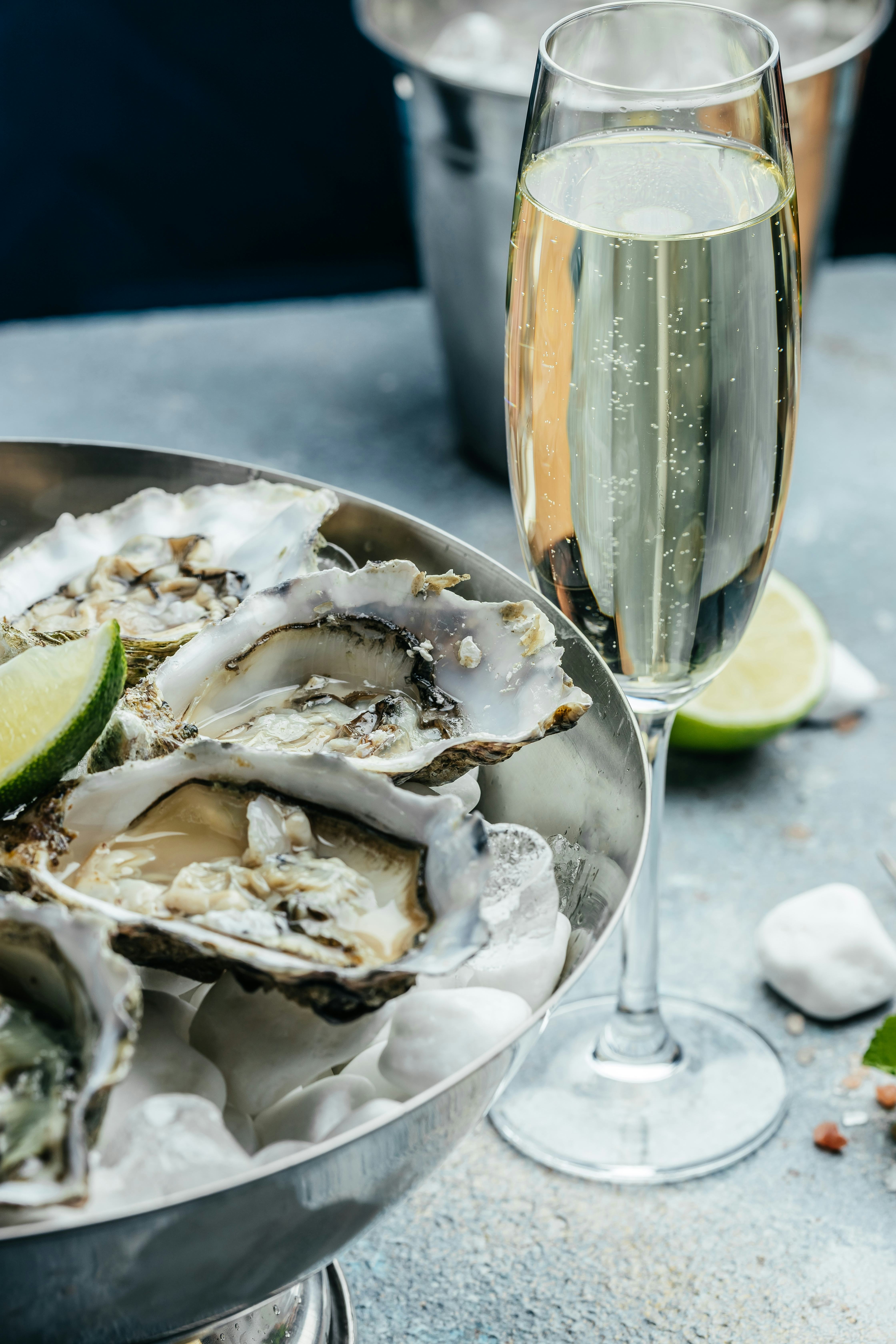 Fresh oysters with lemon and ice. Restaurant delicacy. oysters dish. Oyster dinner with champagne in...