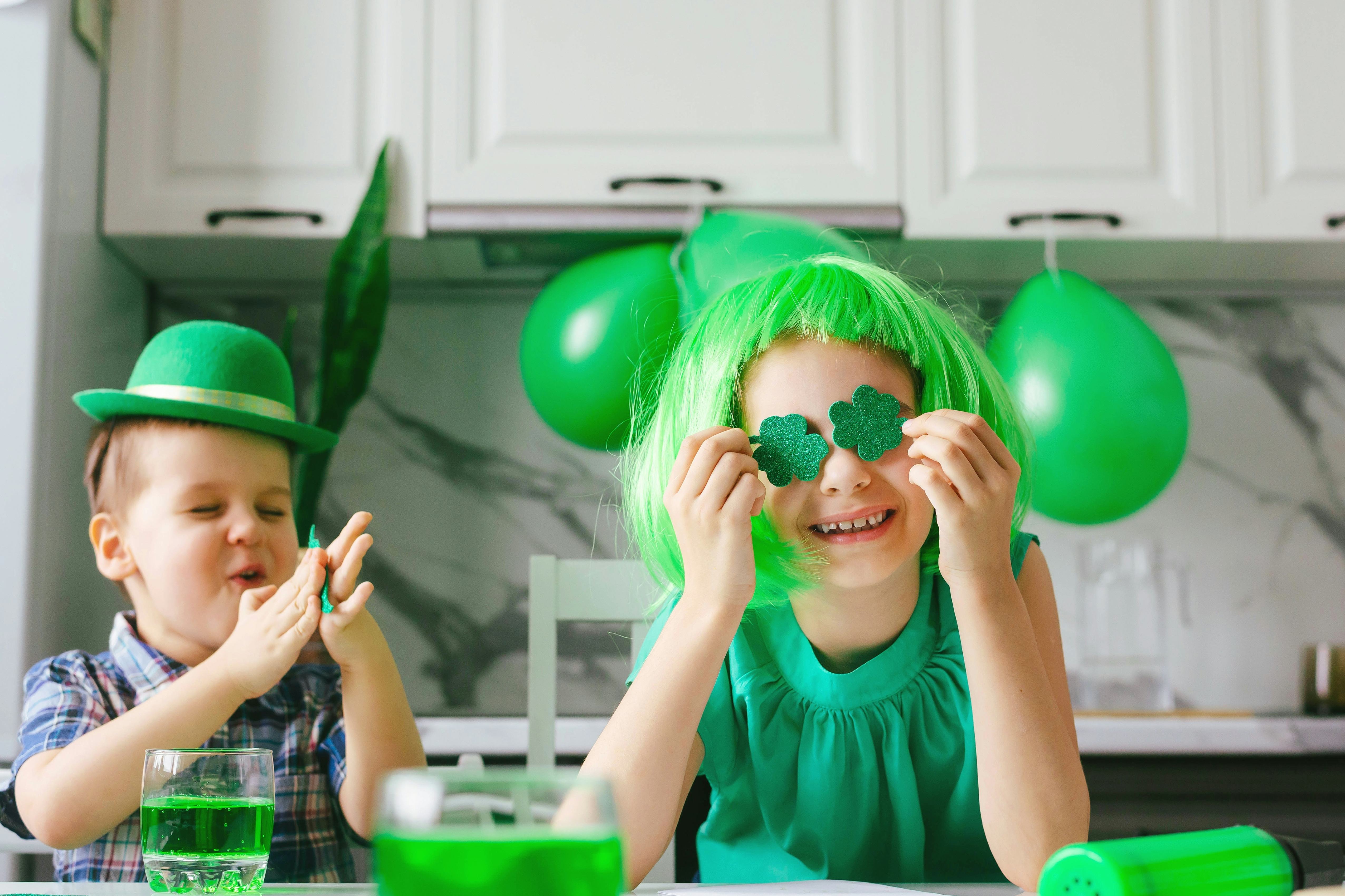Two toddler boy and girl celebrate the holiday on March 17. Child celebrate St. Patrick's Day. Tradi...
