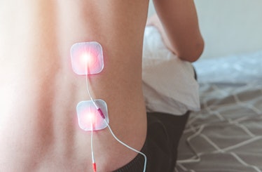 Selective focus on TENS Electrode Pads prepare for treatment on backpain, Electro stimulation machin...