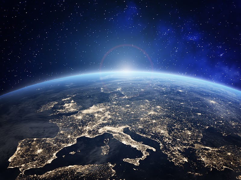 Planet Earth viewed from space with city lights in Europe. World with sunrise. Conceptual image for ...