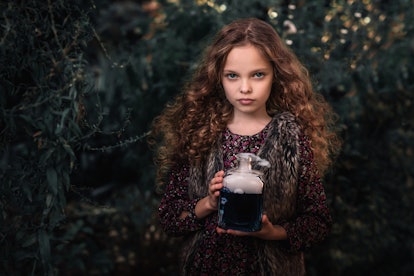 A little girl dressed as an enchantress.