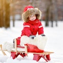Portrait of beautiful toddler boy having fun in winter
