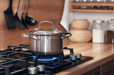 Stainless steel pot cooking on a gas stove.