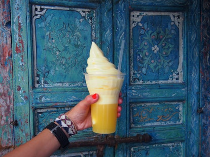 A woman holding a Dole Whip at Disneyland in comparison to the Starbucks Dole Whip drink. 