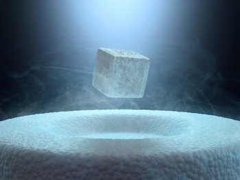 Image concept of magnetic levitating above a high-temperature superconductor, cooled with liquid nit...