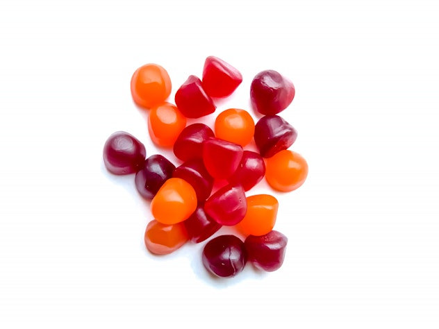 Group of red, orange and purple gummies.