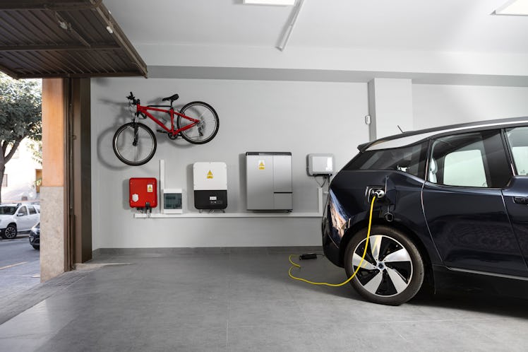 An electric vehicle charging at home in a garage.