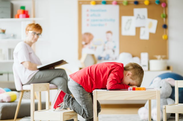 Cute little boy with ADHD during session with professional therapist