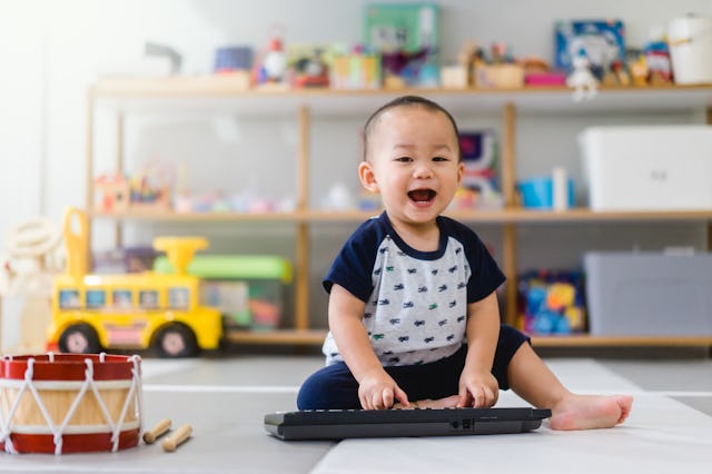 Little baby boy play keyboard and drum at home.Asian boy playing and singing happy moment in music t...