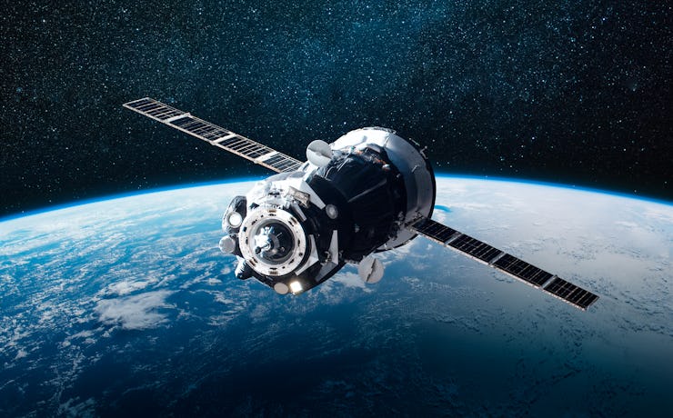 Cargo space craft and Earth planet. Dark background. Sci-fi wallpaper. Elements of this image furnis...