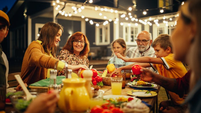 Group of Multiethnic Diverse People Having Fun, Communicating with Each Other and Eating at Outdoors...