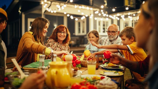 Group of Multiethnic Diverse People Having Fun, Communicating with Each Other and Eating at Outdoors...