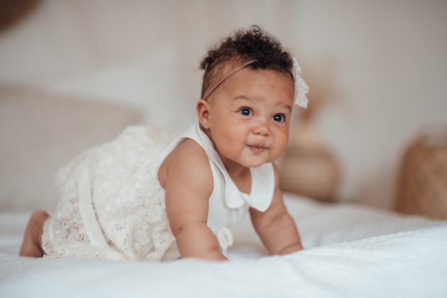 African American baby smiles; "Goldie" is a great Gemini name for baby girls.