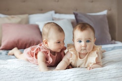 Lifestyle two sisters baby girls dissimilar twins at home
