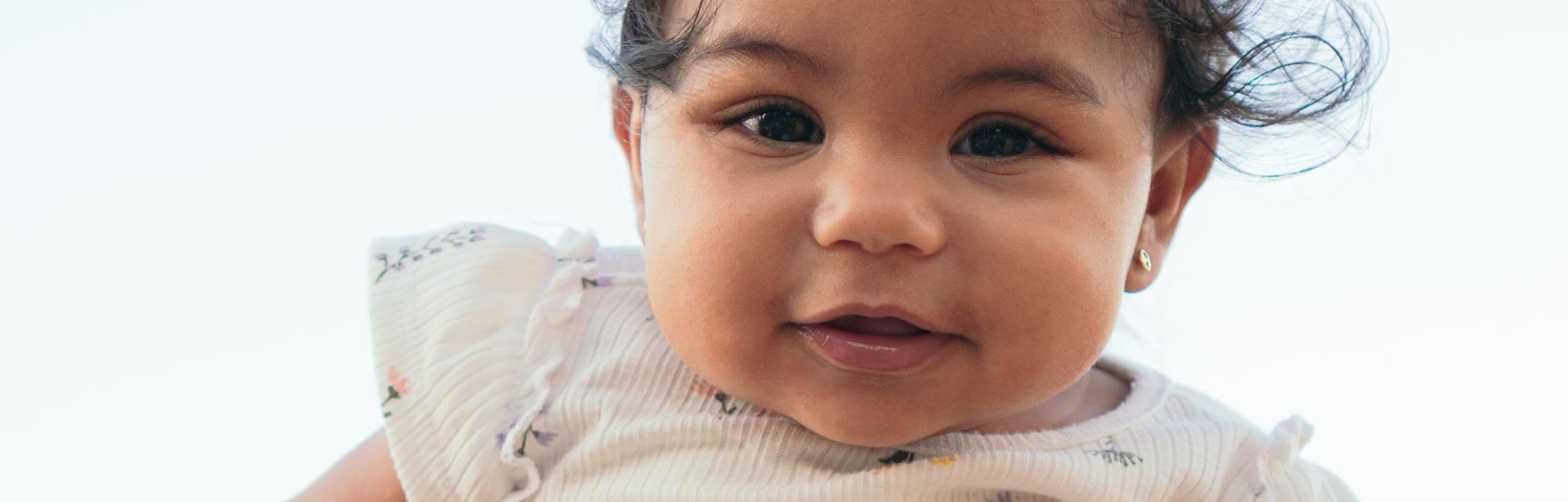 Portrait of a smiling baby outdoors at the park