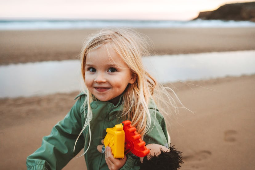 Girl walking on the beach; Gioia is a great Gemini baby name.