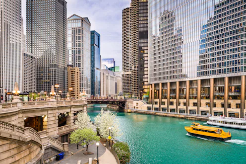 Chicago, Illinois, USA sightseeing cruise and skyline on the river.