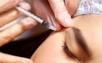 Botox injection close-up of the face, the background is blurred, injections to smooth out wrinkles, ...
