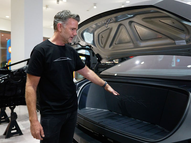 Tesla chief designer Franz von Holzhausen shows off the trunk of a Cybertruck at the Petersen Automo...
