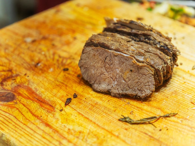 Slicing beef meat for Kazakh beshparmak. Preparation of horse meat by the chef for hot dishes. Cutti...