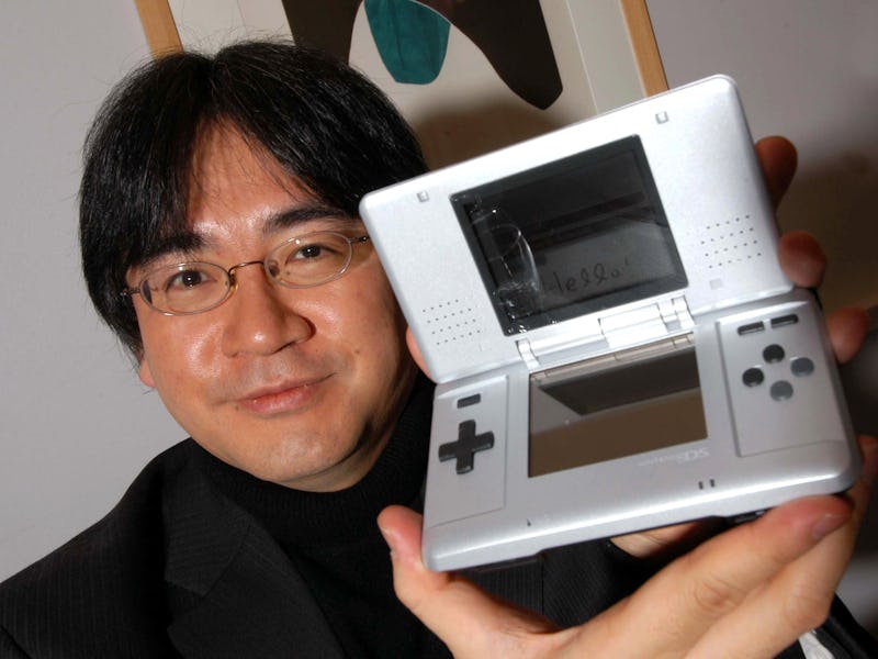 Satoru Iwata, President of Nintendo with the Nintendo DS hand held games console