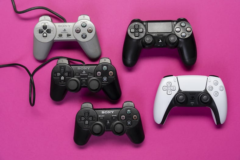 Different generations of game controllers of the Playstation game console, from model 1-5 in front o...
