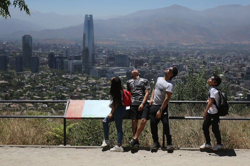 People watch a solar eclipse, in Santiago de Chile, Chile, 14 December 2020. A solar eclipse, partia...