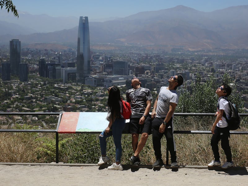 People watch a solar eclipse, in Santiago de Chile, Chile, 14 December 2020. A solar eclipse, partia...