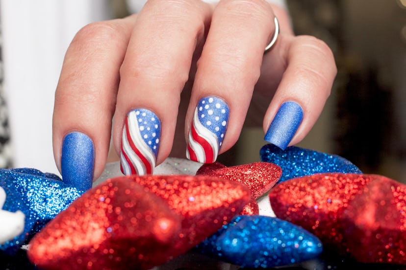 A Fourth of July nail art design with waving flags.