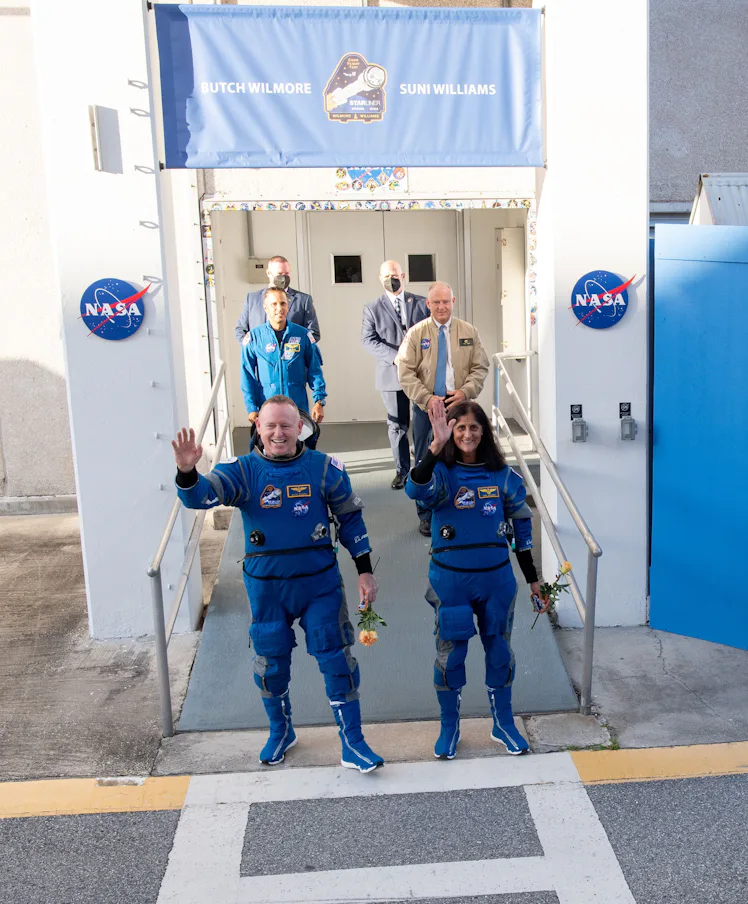 NASA astronauts Butch Wilmore (L, front) and Suni Williams (R, front) wave before boarding Boeing's ...