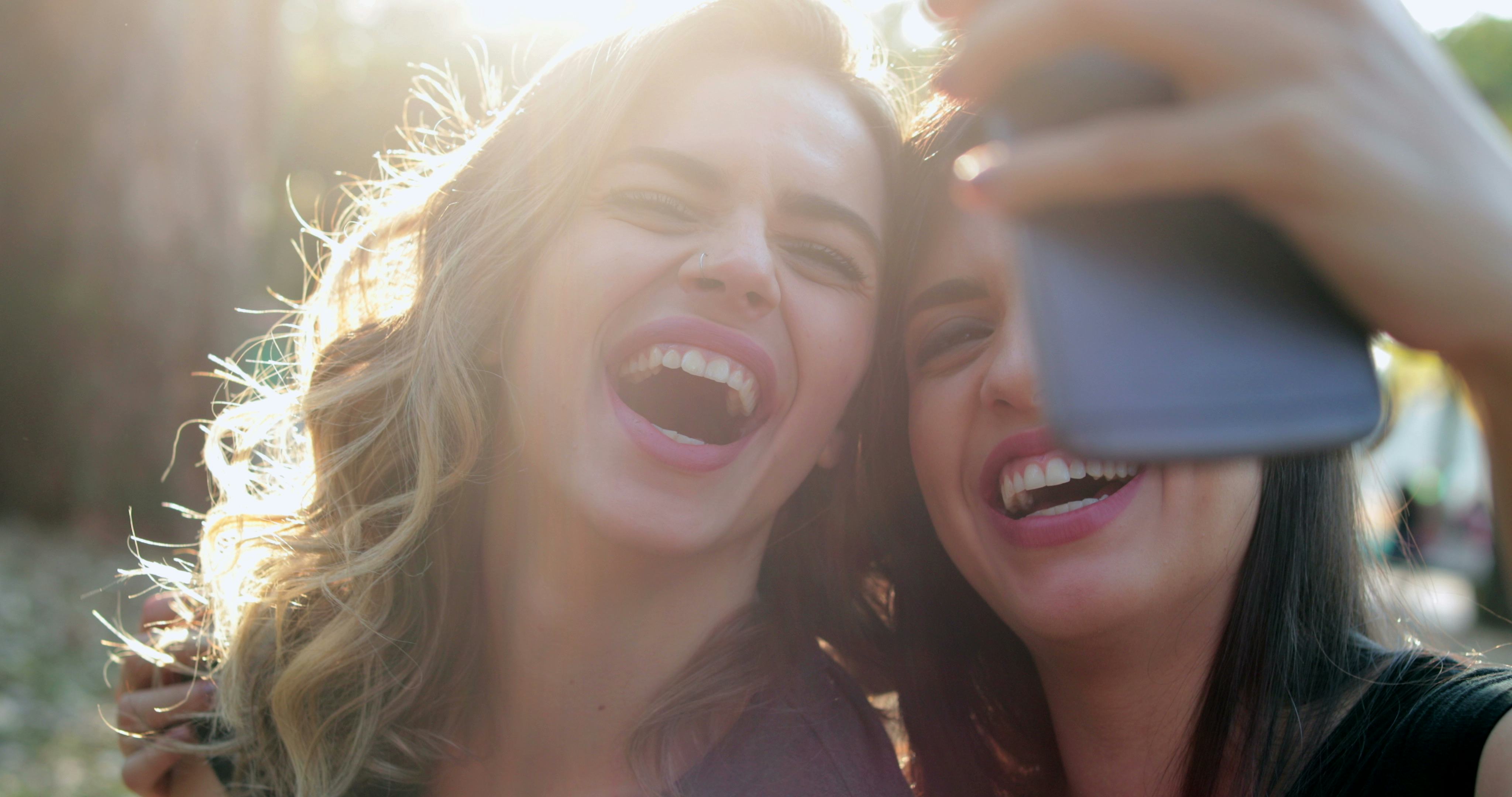 Friends posing for a selfie and laughing