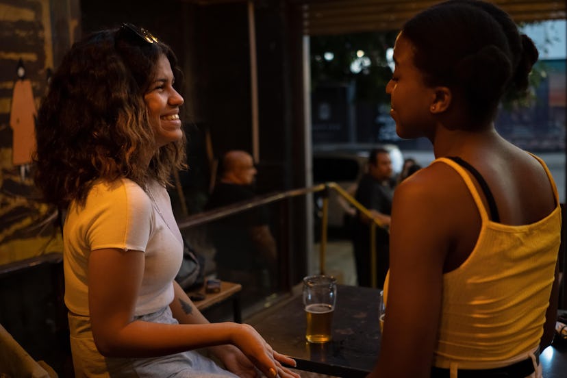 Women sitting at table in pub talking and laugh
