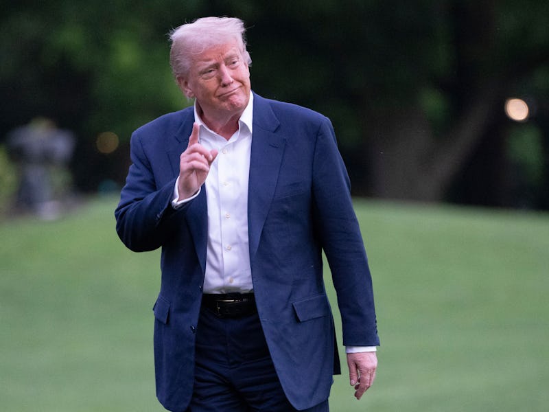 United States President Donald J Trump gestures to the media as he returns to the White House in Was...