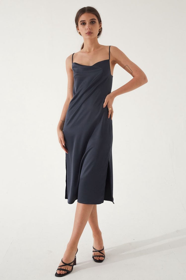 An Almina Concept's black silk slip dress.