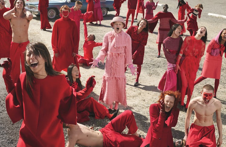 Sarah Brannon on a shoot for W magazine surrounded by group of people in red outfits