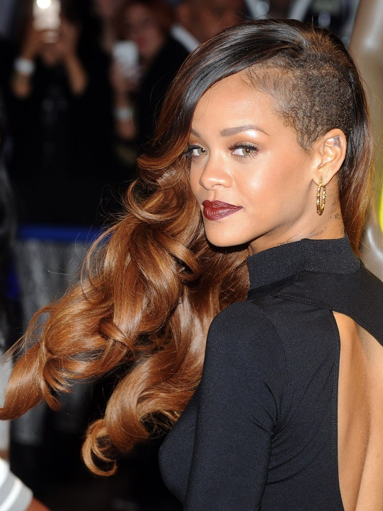Rihanna at the launch of her River Island collection with ombre side-swept curls, a shaved undercut,...