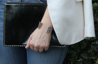 Hoffman holding a black bag while wearing a Céline bracelet