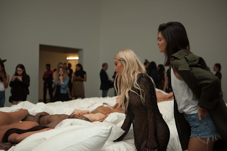 Kim Kardashian and Kendall Jenner looking at Kanye West's Famous sculpture