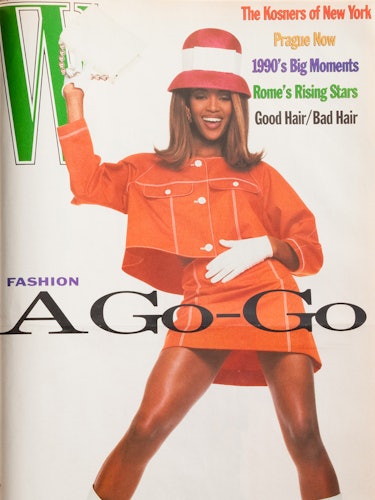 Naomi Campbell in an orange jacket and skirt on the cover of W Magazine 1990