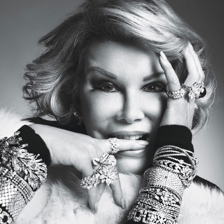 Joan Rivers wearing a Paule Ka turtleneck and a lot of rings and bracelets on her hands