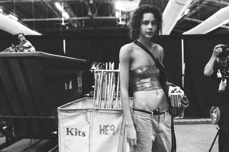 A model holding a cup of coffee backstage at Alexander Wang Spring 2017