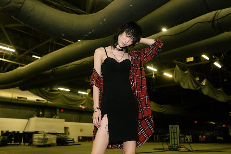 A model wearing Alexander Wang black cocktail dress and a checked shirt 