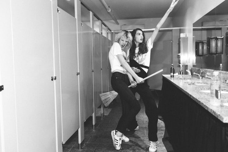 Models posing with a broom in a bathroom backstage at Alexander Wang Spring 2017