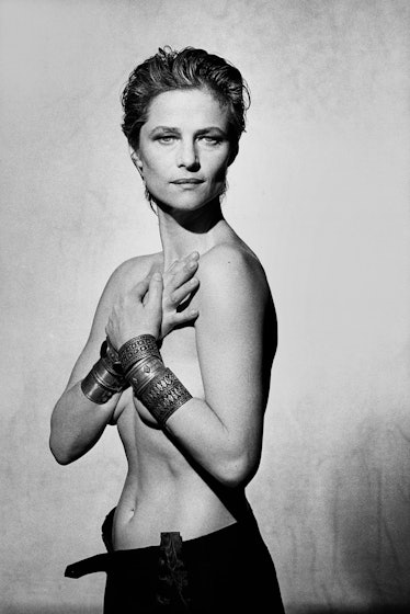 Topless Charlotte Rampling posing for a photo with hands over her naked body