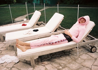 A model lying on a sunbed in matching pink sweatpants in Vetements Summer Camp 