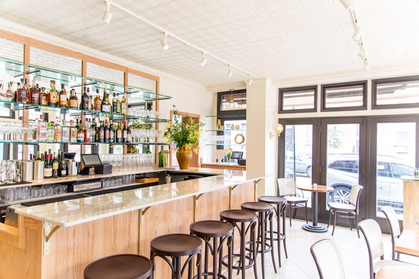 Inside new restaurant King with a bar, several chairs and liquor